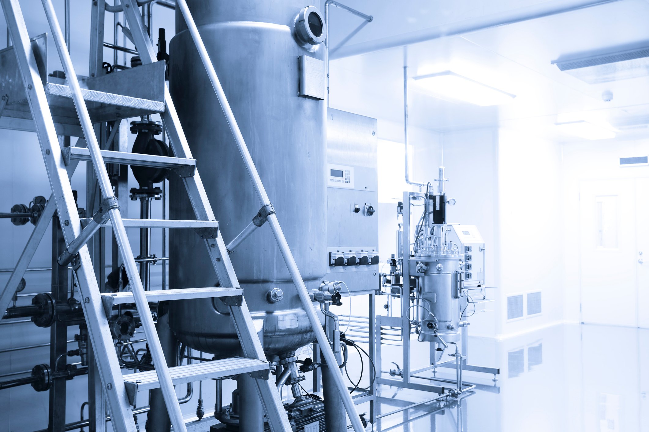 A Blue And White Photo Of A Factory With A Ladder